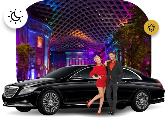 A glamorous promotional image for nightlife or event transportation. A couple, the woman in a red dress and the man in a suit, stands next to a luxurious black Mercedes-Benz S-Class sedan. The background is a composite image showing a modern, brightly lit interior or atrium with a colorful, criss-crossing roof structure and buildings illuminated by neon lights, suggesting a vibrant entertainment district or casino at night. Two icons are included: a crescent moon and stars (night) and a single star (luxury/special event).